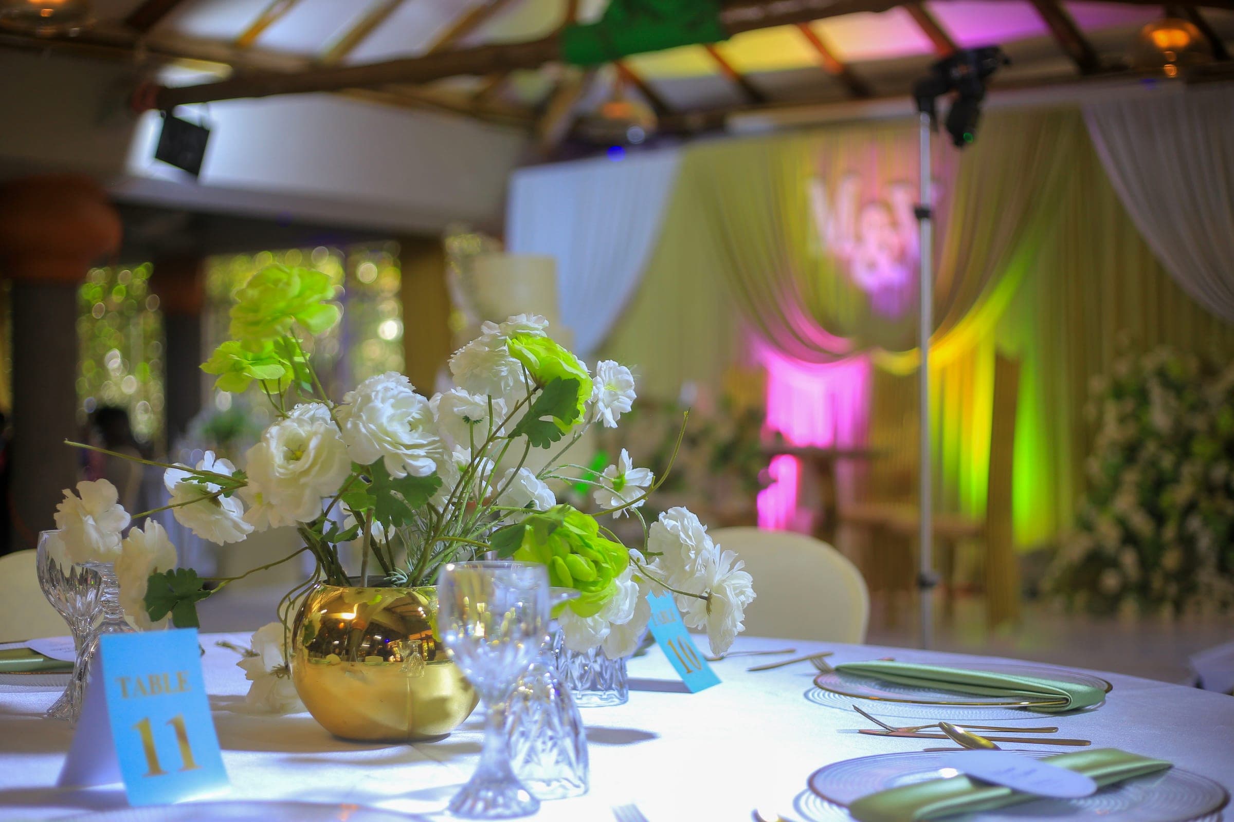 Green and white centrepiece in a gold footed vase