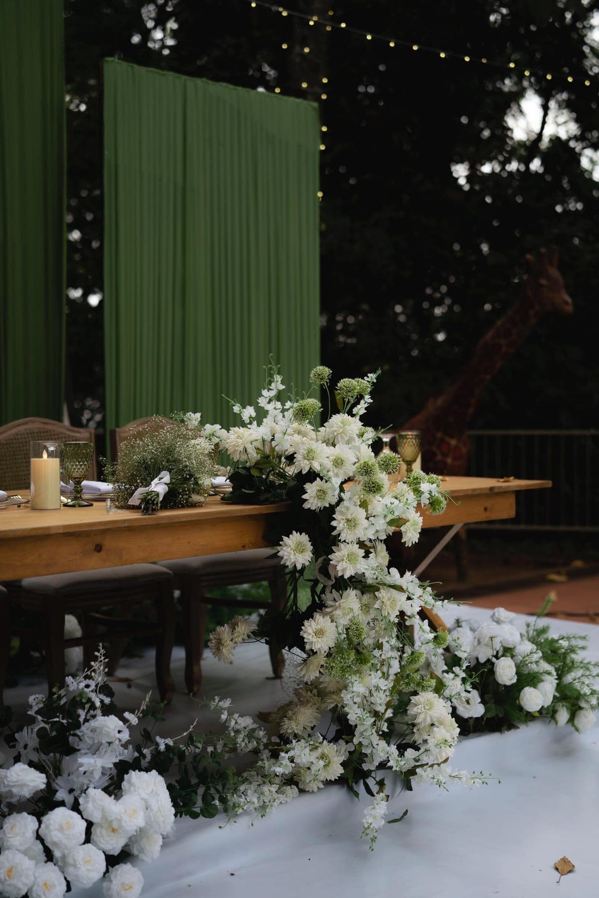 Long head table running with white florals and candles