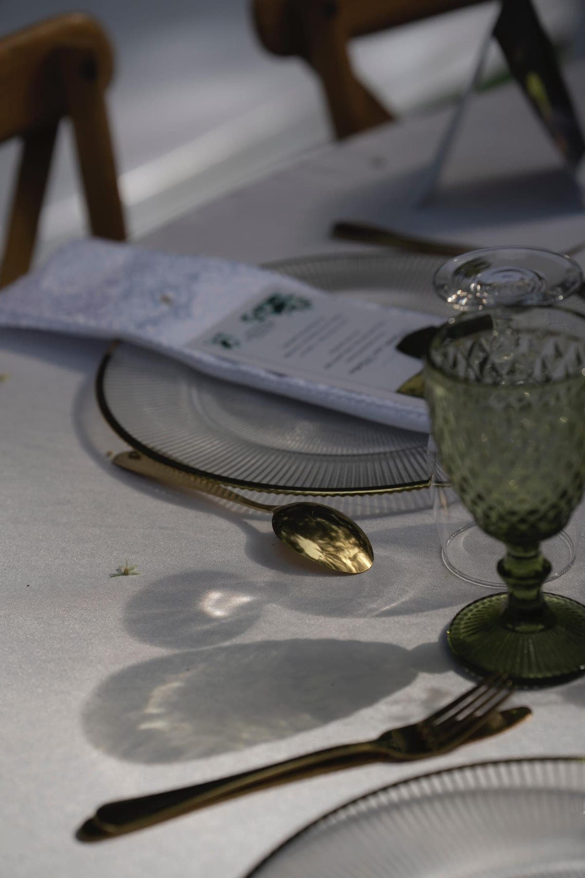 Place setting with a green goblet and folded linen